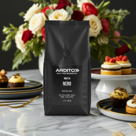 A black bag of ARDITO Nero espresso coffee stands on a marble surface with flowers and pastries in the background.